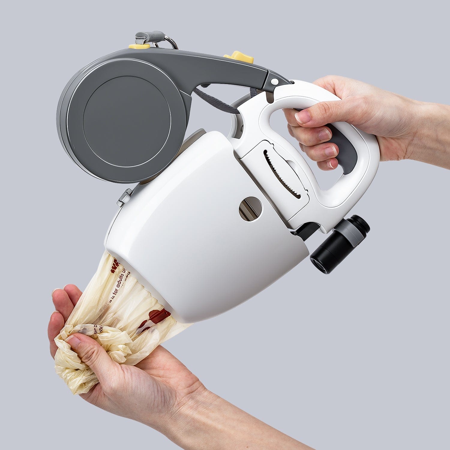 Hands demonstrating how to remove a used dog waste bag from the Furrbby leash pooper scooper